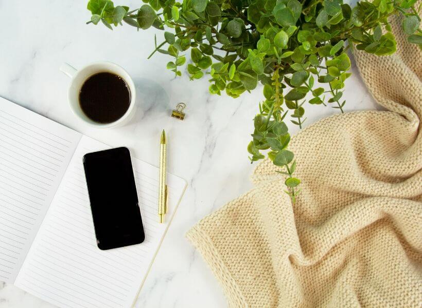 phone, notebook, and blanket