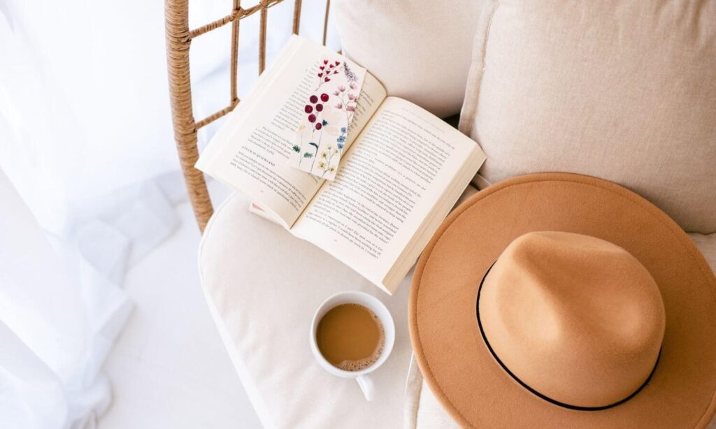 hat, books, cup of coffee on chair