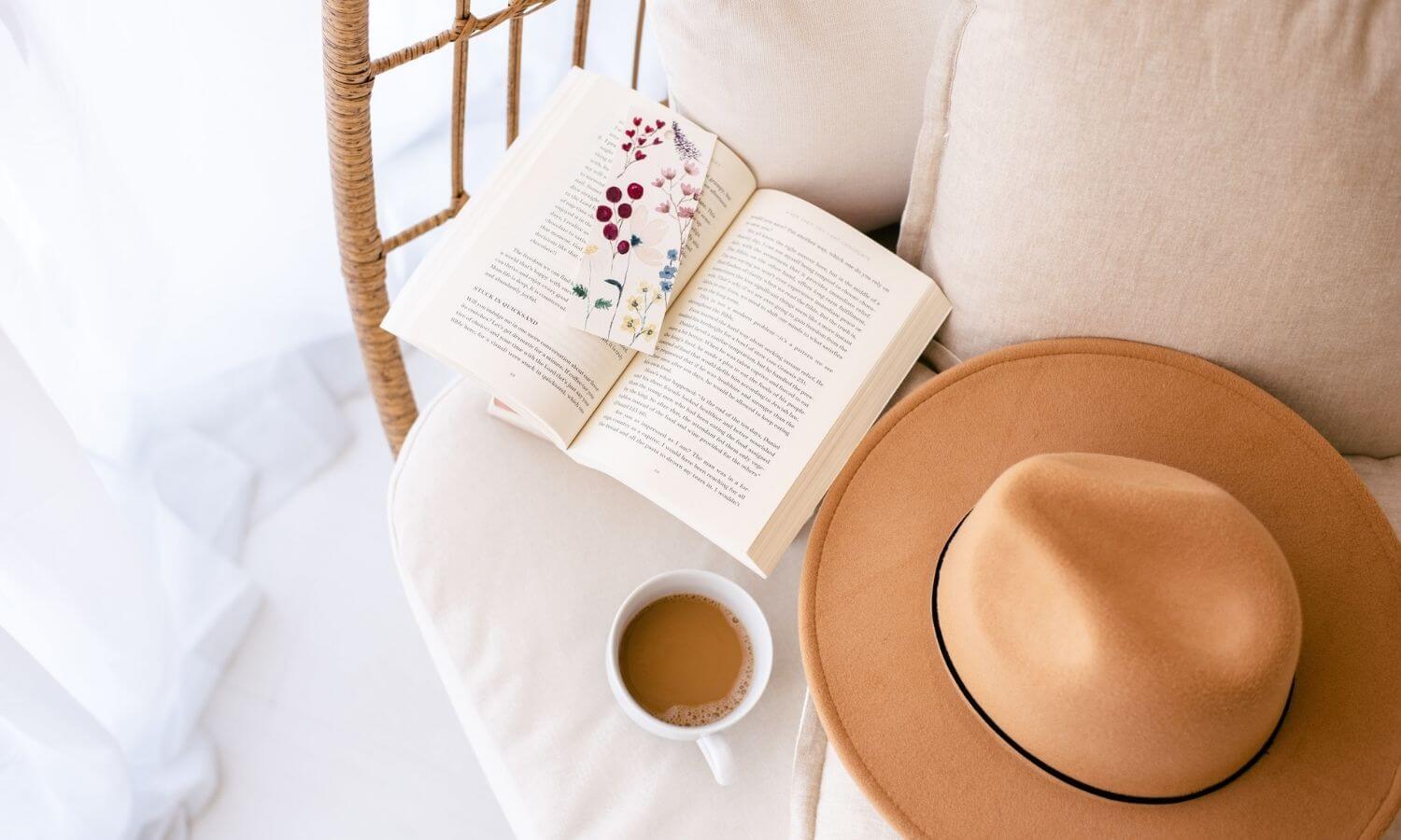 hat, books, cup of coffee on chair