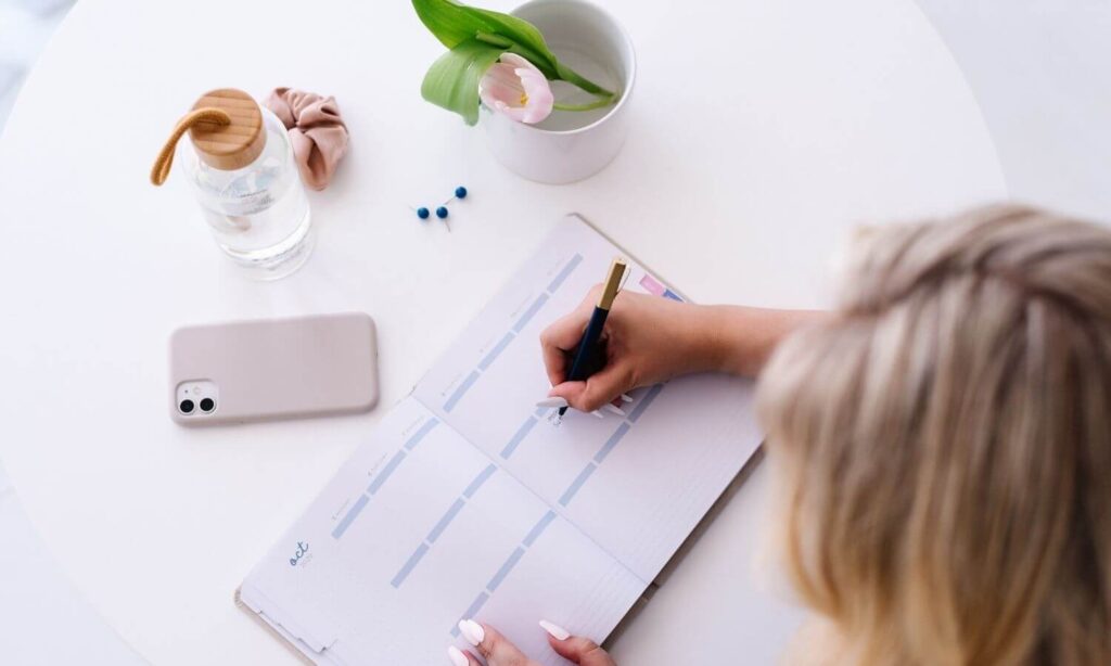 Woman planning out her week at a table