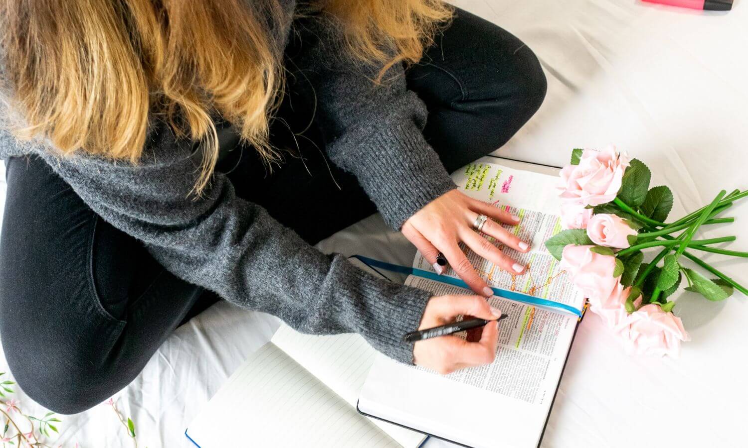 Woman studying her Bible and marking passages