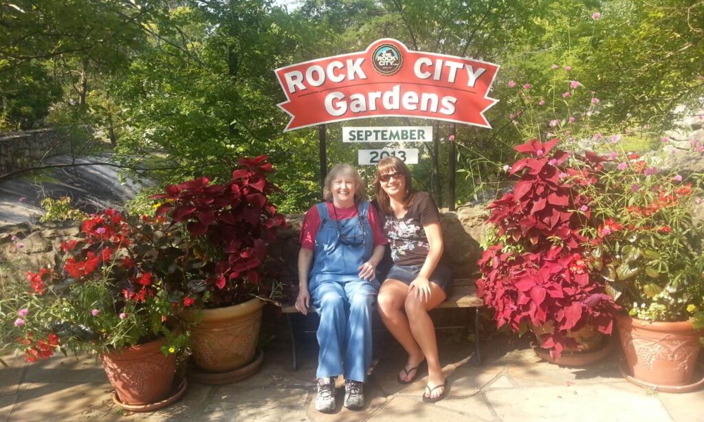 Mom and me sitting on a bench in front of sign that says Rock City September 2013